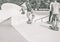 Group of skaters friends performing trick in skate park - Young men training with skateboards - Extreme sport, youth, lifestyle,