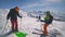 A group of skiers checks their skis before skiing in the snowy mountains. Tian Shan mountains, Shymkent, Kazakhstan -