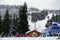 A group of skiers and snowboarders waiting in line to hitch a ride up the ski lift on Cypress Mountain