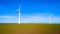 A group of sleek wind turbines stand tall in a vibrant field in Flevoland, windmill turbines on land