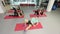 A group of slender girls with fitness instructor works with a coach in a fitness gym.