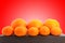 Group of small and big tangerines or mandarin oranges shot over red background