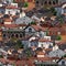 Group of small houses in a mountains with white walls and red tiled roofs