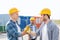 Group of smiling builders in hardhats outdoors