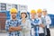 Group of smiling builders in hardhats outdoors