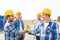 Group of smiling builders shaking hands outdoors