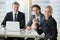 Group of smiling businessmen at the modern office desk