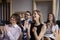 Group of smiling businesspeople clap hands welcoming corporate trainer