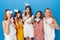 A group of smiling caucasian girls to have gender reveals envent, isolated blue background.