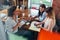 Group of smiling creative women discussing a project sitting around table making notes in office