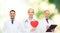 Group of smiling doctors with red heart shape