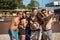 Group of smiling european friends making selfie on beach court