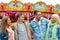 Group of smiling friends in amusement park