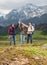 Group of smiling friends with backpacks hiking