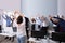 Group Of Smiling Multi-ethnic Businesspeople Doing Exercise