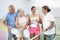 Group of smiling pickleball players talking on indoor court