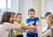 Group of smiling school kids putting hands on top