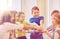 Group of smiling school kids putting hands on top