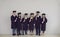 Group of smiling students multiethnic university graduates standing with diplomas in hands