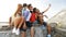 Group of smiling teenagers making selfie outdoors