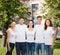 Group of smiling teenagers in white blank t-shirts