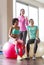 Group of smiling women with exercise balls in gym