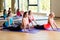 Group of smiling women stretching in gym