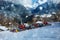 Group of snow groomers over ski lift at mountain winter resort