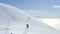 Group snowboarders hiking skitour in snowy mountain for snowboarding freeride