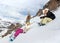 Group of snowboarders resting on mountainside