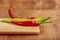 Group spicy peppers on wooden Board