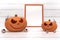 Group spooky halloween pumpkin, Jack O Lantern, with an evil face and eyes , ghost spider, photo frame and eyeball on a white wood
