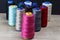 Group of spools of thread of various colors