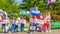 A group of sports children with Russian flags and sports posters in the park on a summer day. Russian text: Russia forward, Victor
