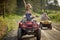 Group of sporty friends driving quads together