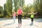 Group of sporty people jumping rope outdoors