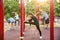 Group of sporty people training on athletic field outdoors