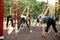 Group of sporty people training on athletic field outdoors