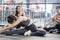 Group of sporty young asian women in sportswear warming up with gymnastics and stretching exercises