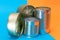 A Group of Stacked Tin Cans with Blank Edges on Split Blue and Orange Background