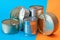 A Group of Stacked Tin Cans with Blank Edges on Split Blue and Orange Background