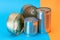 A Group of Stacked Tin Cans with Blank Edges on Split Blue and Orange Background