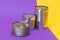 A Group of Stacked Tin Cans with Blank Edges on Split Yellow and Violet Background