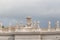 Group of statues of Peter`s Square Colonnade with rainy clouds on background, Vatican city state, Italy