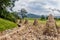 Group of stone cairns at edge of field near treeline in public park