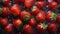 a group of strawberries floating in a pool of water with drops of water on them and on top of each other, with a green stem