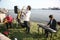 Group of street musicians in the background of the Gulf of Finland in the civil port of Kronstadt.