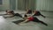 Group stretching class with a trainer in a large hall.