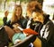 Group of students on grass, prepaing to exam