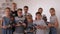 A group of students holds many different robots in a robotics lesson at school.